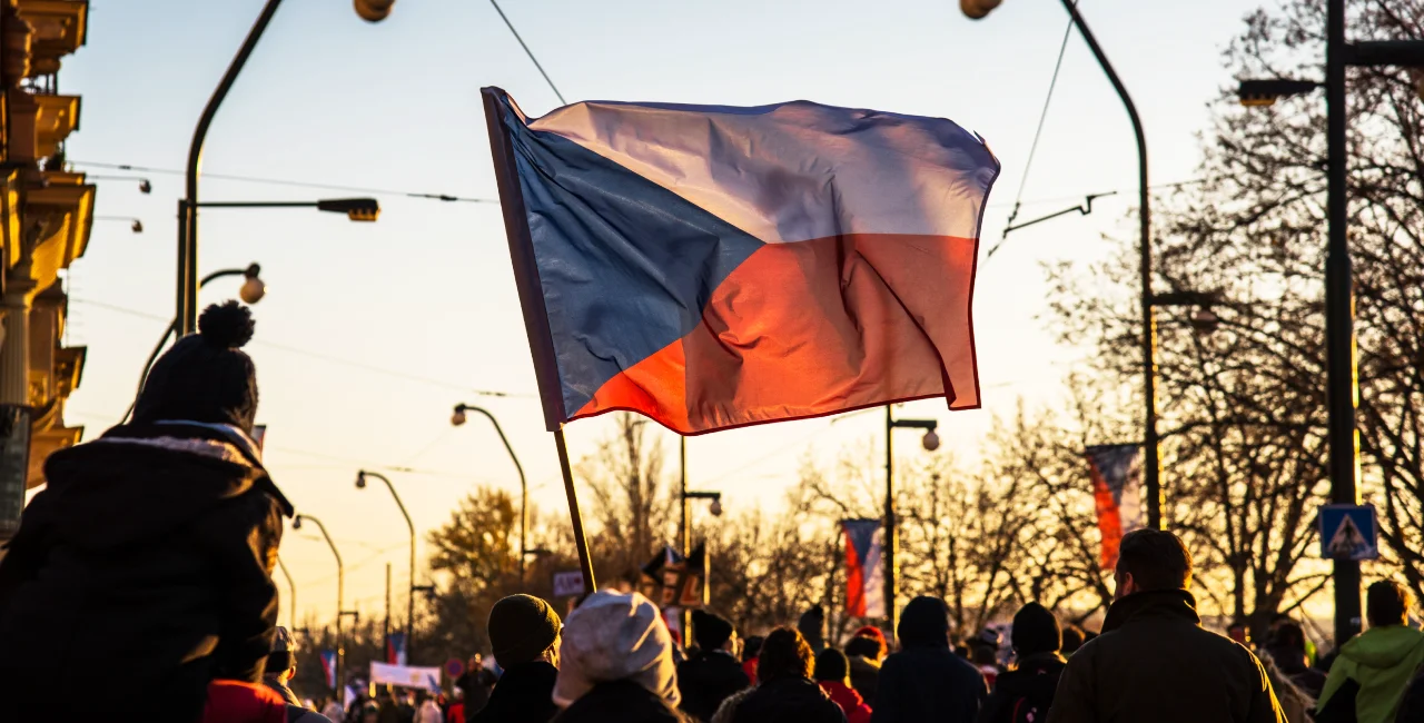 A Czech flag flies during Nov. 17 celebrations in Prague. Photo: Shutterstock / Papuchalka - kaelaimages